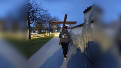 Ein junger Erwachsener trägt das Kreuz während des Kreuzwegs.  (Bild: Patrick Hummer)